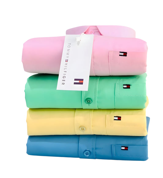 Stack of folded shirts in pink, green, yellow, and blue with a Tommy Hilfiger tag