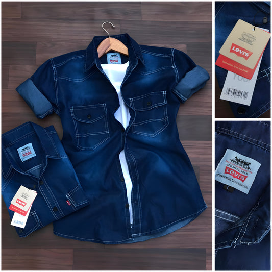 Levis Blue denim Jeans shirt with Levi's tags on a wooden surface